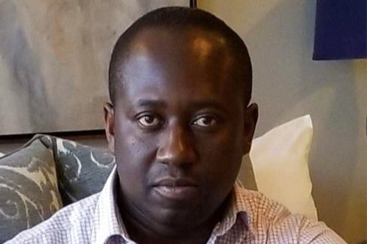 A man sits staring directly into the camera.