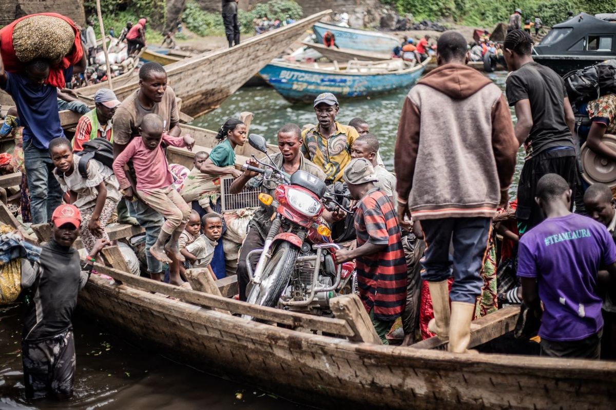 Congolese displaced fleeing the area of Minova board with their belongings boat leaving the port of Nzulo on January 21, 2025 to seek shelter in Goma.