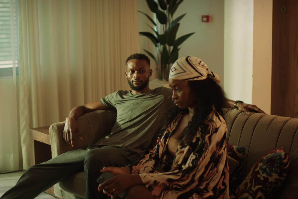 ​An image from the film 'The Weekend' of two people sitting on a couch, looking serious.
